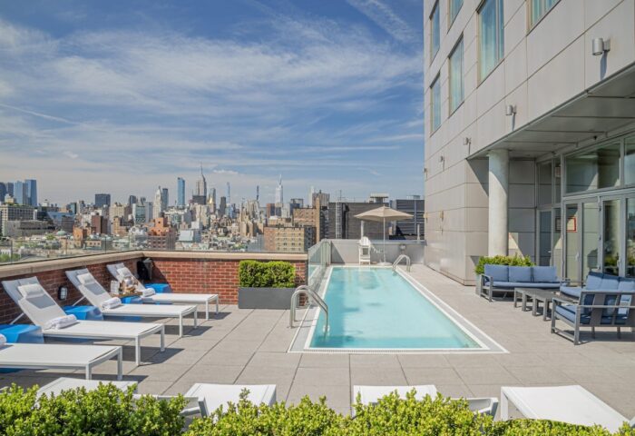 Hotel Indigo Lower East Side's rooftop pool and NYC skyline view. A gay-friendly hotel for an unforgettable urban getaway.