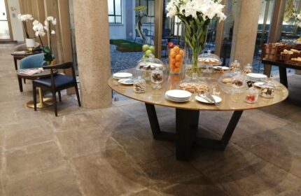 Hotel Indigo Milan Corso Monforte: Breakfast buffet with cakes, fruit, and pastries. Gay-friendly hotel with stylish interior design.
