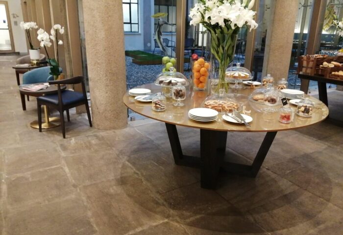 Hotel Indigo Milan Corso Monforte: Breakfast buffet with cakes, fruit, and pastries. Gay-friendly hotel with stylish interior design.