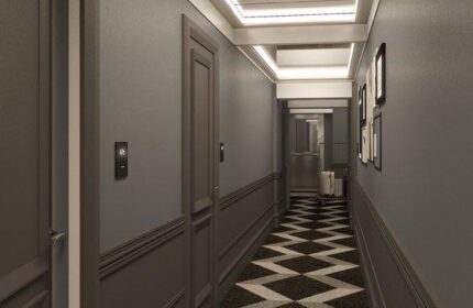 Hotel Indigo Milan Corso Monforte hallway. Gay-friendly hotel with a stylish interior. Modern design with a black and white patterned carpet.