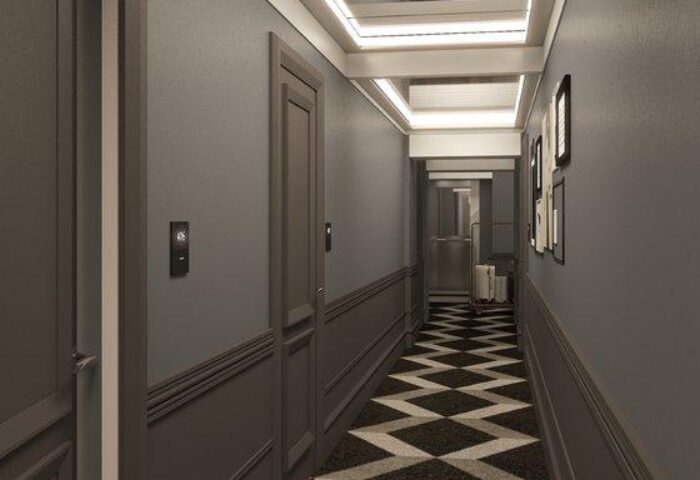 Hotel Indigo Milan Corso Monforte hallway. Gay-friendly hotel with a stylish interior. Modern design with a black and white patterned carpet.