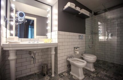 Hotel Indigo Milan Corso Monforte gay-friendly hotel bathroom. Classic design with modern fixtures, walk-in shower, and stylish tile work.