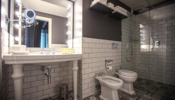 Hotel Indigo Milan Corso Monforte gay-friendly hotel bathroom. Classic design with modern fixtures, walk-in shower, and stylish tile work.