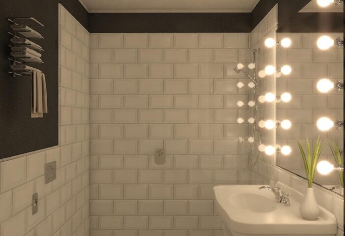Hotel Indigo Milan Corso Monforte gay-friendly bathroom. Bright mirror lights, white tiles, and patterned floor. Modern design.