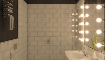 Hotel Indigo Milan Corso Monforte gay-friendly bathroom. Bright mirror lights, white tiles, and patterned floor. Modern design.