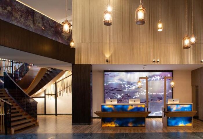 Hotel Indigo Phuket Patong lobby. Gay-friendly hotel with modern design, stylish lighting, and a welcoming reception area. Stairs on the left.