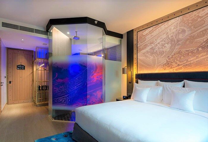 Hotel Indigo Phuket Patong gay-friendly hotel room. Modern design with a glass-enclosed shower, king bed, and unique decor.