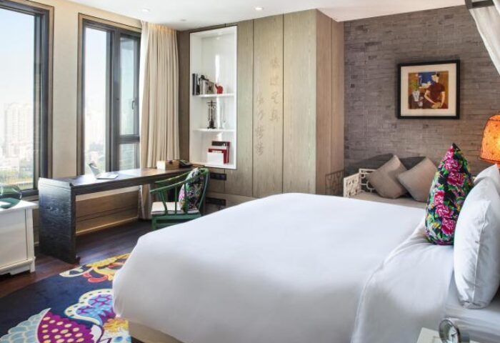Hotel Indigo Shanghai On The Bund room. Gay-friendly hotel with desk, bed, and city view. Modern design, comfortable stay in Shanghai.