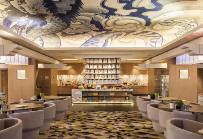 Hotel Indigo Shanghai On The Bund's gay-friendly dining area. Buffet, tables, chairs, and dragon art on the ceiling. Elegant design.