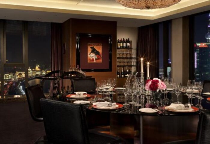 Hotel Indigo Shanghai On The Bund dining room at night. Gay-friendly hotel with city view. Luxury travel experience.