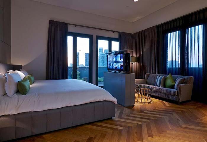 Hotel Indigo Tel Aviv Diamond District gay-friendly room. Modern design, balcony view, TV, and herringbone wood floor. Perfect for gay travelers.