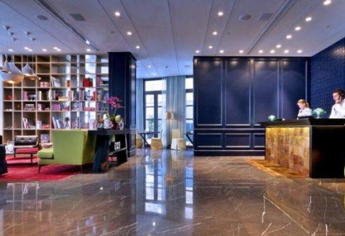 Hotel Indigo Tel Aviv Diamond District lobby. Gay-friendly hotel with stylish design, reception desk, and lounge area. Modern, upscale ambiance.