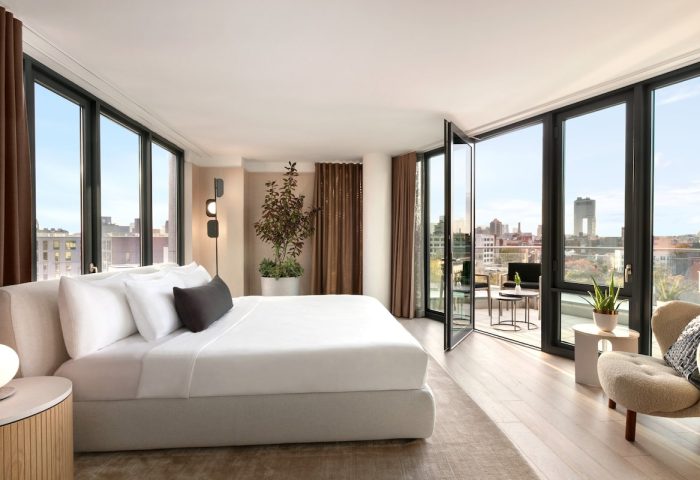 Hotel Indigo Williamsburg Brooklyn room with balcony. Gay-friendly hotel featuring city views, modern design, comfortable bed, and stylish decor.