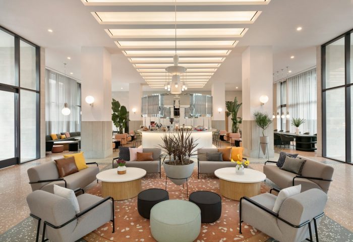 Hotel Indigo Williamsburg, Brooklyn lobby. Gay-friendly hotel with modern design, seating areas, and a bar. Interior of the hotel.
