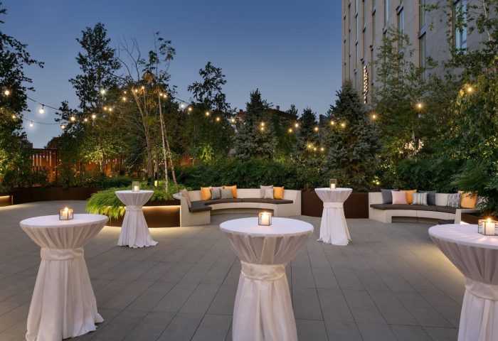 Hotel Indigo Williamsburg Brooklyn outdoor terrace. Gay-friendly hotel with cocktail tables, seating, and string lights. Perfect for events.