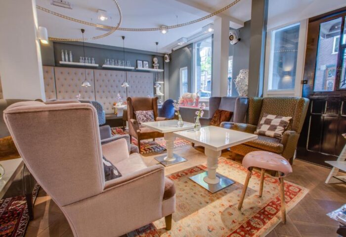 Hotel JL No76's gay-friendly lounge area. Stylish seating, tables, and decor create a welcoming space for gay travelers in Amsterdam.