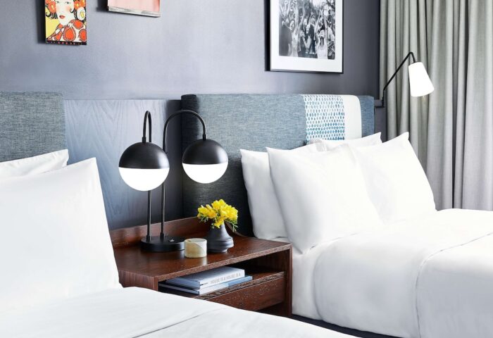 Hotel Kabuki, part of Jdv by Hyatt, a gay-friendly hotel. Room with two beds, lamps, and art. Ideal for gay travel in San Francisco.