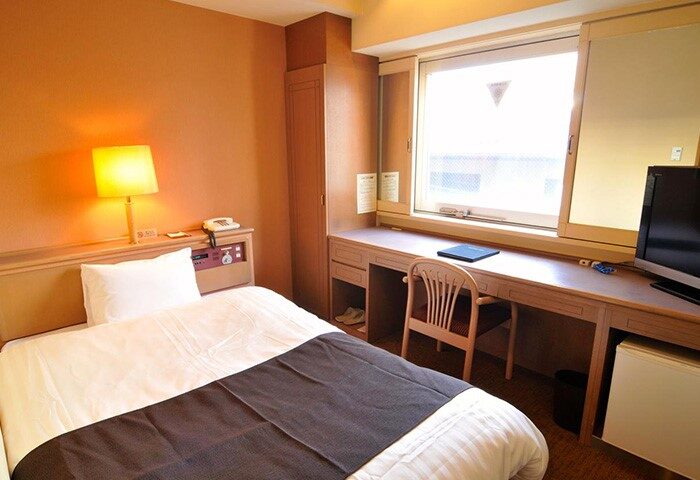 Hotel Listel Shinjuku's gay-friendly room. Bed, desk, chair, and window. Ideal for gay travelers seeking comfort in Shinjuku, Tokyo.