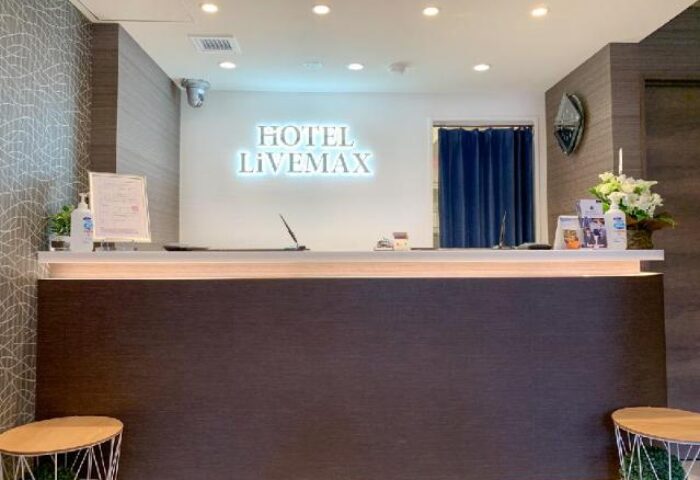 Hotel Livemax Shinjuku-Kabukicho reception area. Gay-friendly hotel with modern design, flowers, and a clean, welcoming atmosphere.