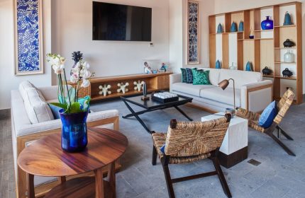 Hotel Luxury Patio Azul: Gay-friendly hotel living room. Sofas, woven chairs, blue accents, and modern decor create a stylish, inviting space.