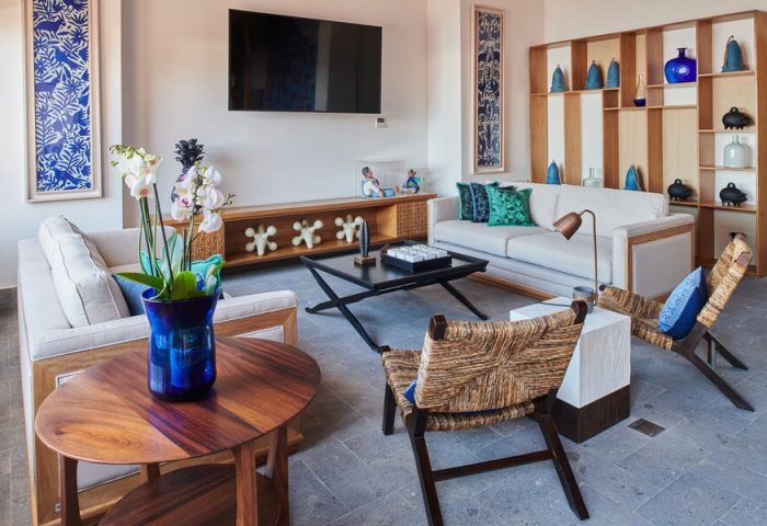 Hotel Luxury Patio Azul: Gay-friendly hotel living room. Sofas, woven chairs, blue accents, and modern decor create a stylish, inviting space.