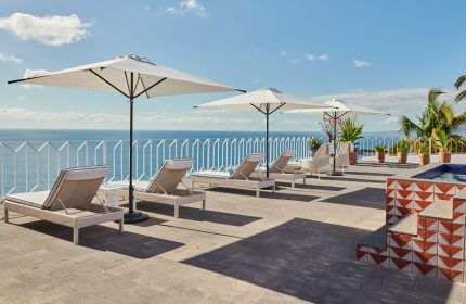 Hotel Luxury Patio Azul: Gay-friendly hotel patio with lounge chairs, umbrellas, ocean view. A relaxing space for gay travelers.