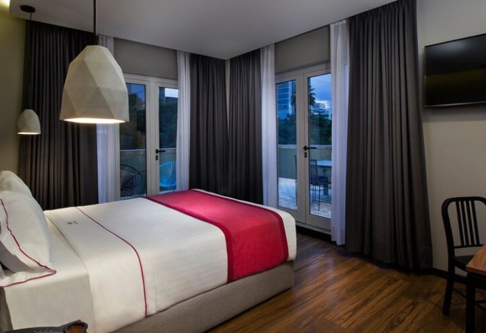 Hotel MX mas reforma gay-friendly room. Modern room with balcony, desk, & geometric lighting. A great choice for gay travelers in Mexico.