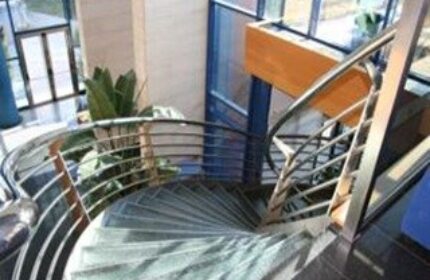 Spiral staircase at Hotel Madeira Centro, a gay-friendly hotel. Interior design detail for gay men's travel. Modern architecture.