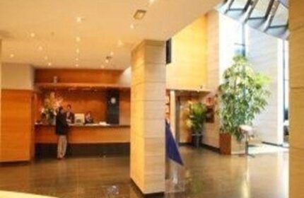 Hotel Madeira Centro's lobby. This gay-friendly hotel features a modern reception area, plants, and a bright, welcoming atmosphere.