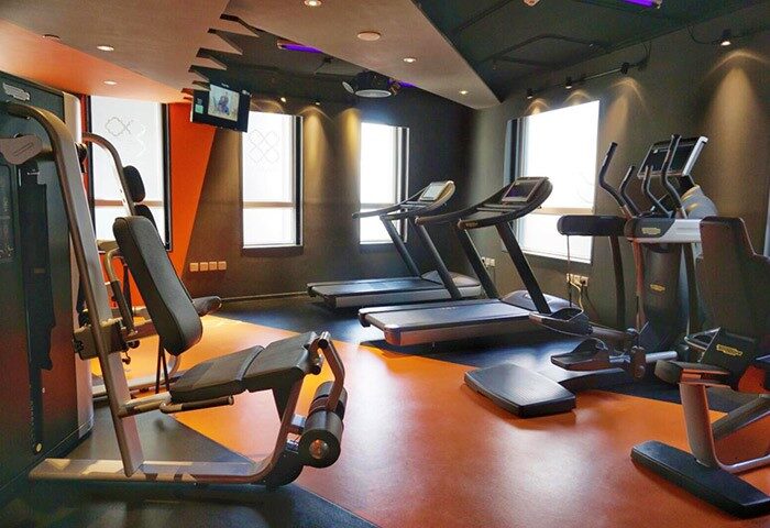 Hotel Madera Hollywood gym. Gay-friendly hotel fitness center with treadmills, weight machines, and elliptical trainer. Modern design.