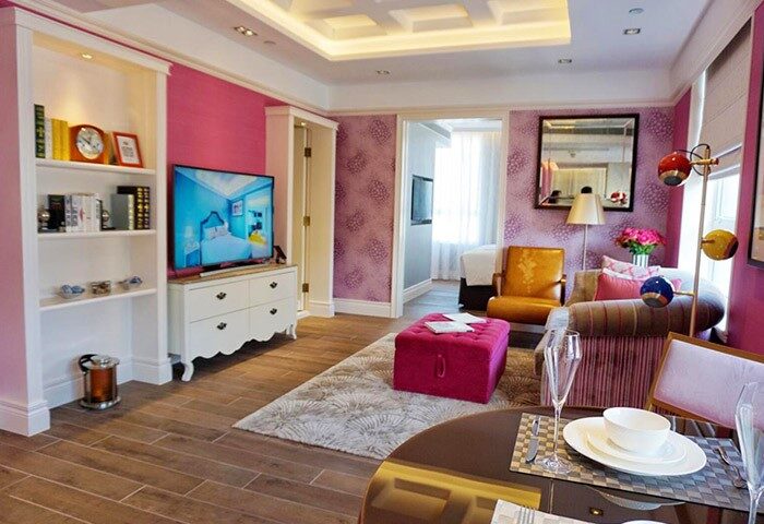 Hotel Madera Hollywood gay-friendly hotel room. Pink walls, TV, sitting area, and dining table. Elegant design for gay travelers.