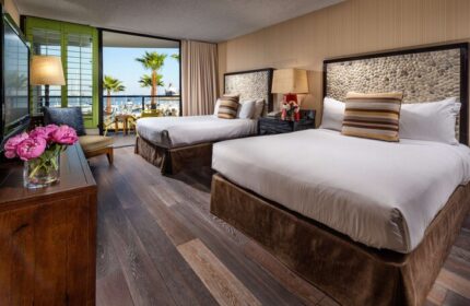 Hotel Maya A Doubletree Hotel gay-friendly room. Two beds, balcony view of palm trees and marina. Gay travel lodging at its finest.