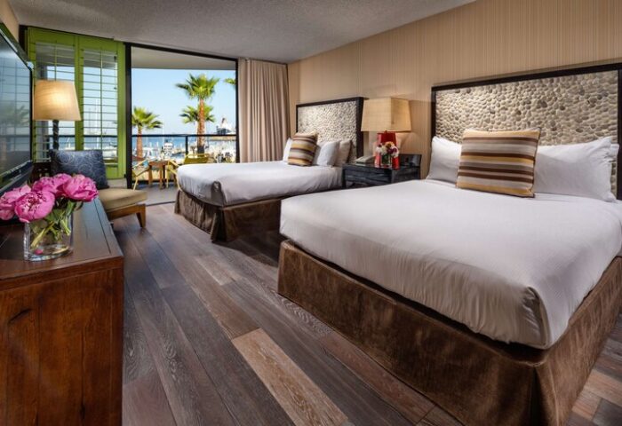 Hotel Maya A Doubletree Hotel gay-friendly room. Two beds, balcony view of palm trees and marina. Gay travel lodging at its finest.