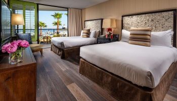 Hotel Maya A Doubletree Hotel gay-friendly room. Two beds, balcony view of palm trees and marina. Gay travel lodging at its finest.