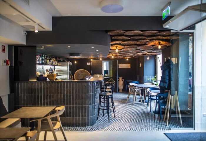 Hotel Memories Budapest's stylish bar area. Gay-friendly hotel with a unique ceiling design, tiled bar, and modern seating. Budapest travel.