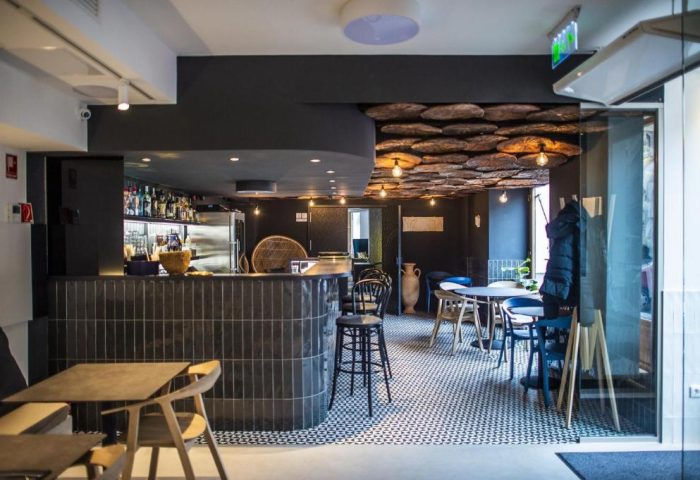 Hotel Memories Budapest's stylish bar area. Gay-friendly hotel with a unique ceiling design, tiled bar, and modern seating. Budapest travel.