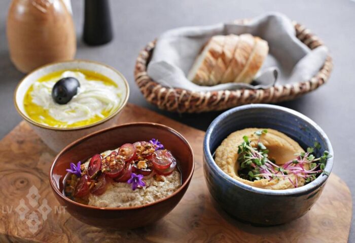 Gourmet dips at Hotel Memories Budapest, a gay-friendly hotel. Hummus, yogurt dip with olive, & baba ghanoush with grapes. Bread basket too.