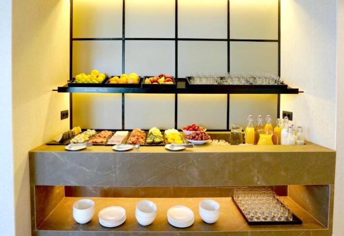 Breakfast buffet at Hotel MiM Sitges, a gay-friendly hotel. Fresh fruit, juices, and pastries are available. Ideal for gay travel.
