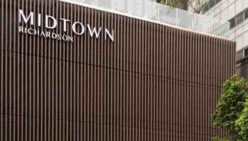 Midtown Richardson Hotel facade. Modern design with vertical slats. Gay-friendly hotel in Richardson. Great for gay men's travel.