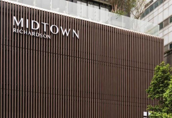 Midtown Richardson Hotel facade. Modern design with vertical slats. Gay-friendly hotel in Richardson. Great for gay men's travel.