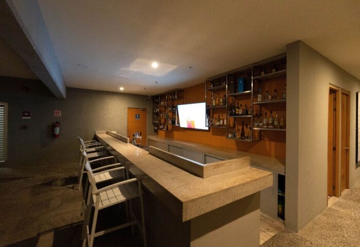 Hotel Mio Vallarta Adults Only bar. Gay-friendly hotel bar with liquor shelves, TV, and stools. Ideal for gay travel in Puerto Vallarta.