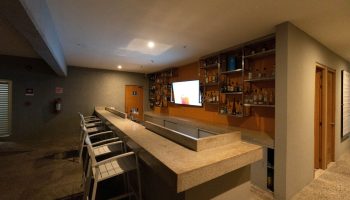 Hotel Mio Vallarta Adults Only bar. Gay-friendly hotel bar with liquor shelves, TV, and stools. Ideal for gay travel in Puerto Vallarta.