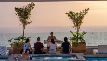 Gay-Friendly Hotel Mio Vallarta Adults Only pool party with DJ. Ocean view at sunset. Perfect for gay travel & vacations in Puerto Vallarta.