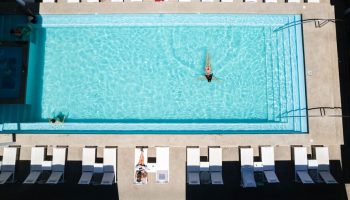 Aerial view of Hotel Mio Vallarta Adults Only pool. A gay-friendly hotel with clear turquoise water and white lounge chairs.