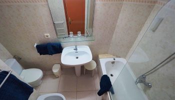 Hotel Montserrat bathroom. Interior of a gay-friendly hotel room featuring a sink, toilet, bidet, and bathtub with shower.
