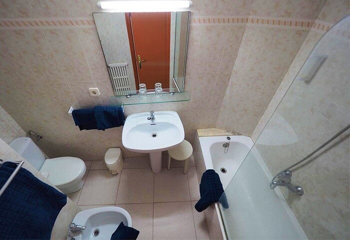 Hotel Montserrat bathroom. Interior of a gay-friendly hotel room featuring a sink, toilet, bidet, and bathtub with shower.