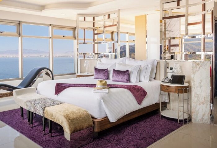 Hotel Mousai Cancun adults-only all-inclusive gay-friendly hotel room. Luxurious suite with ocean view, chaise lounge, and stylish decor.