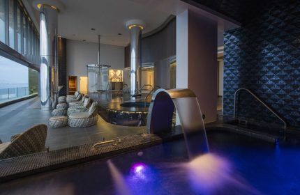 Hotel Mousai Cancun Adults Only All Inclusive spa. Gay-friendly hotel with pool, waterfall feature, lounge chairs, and ocean view.