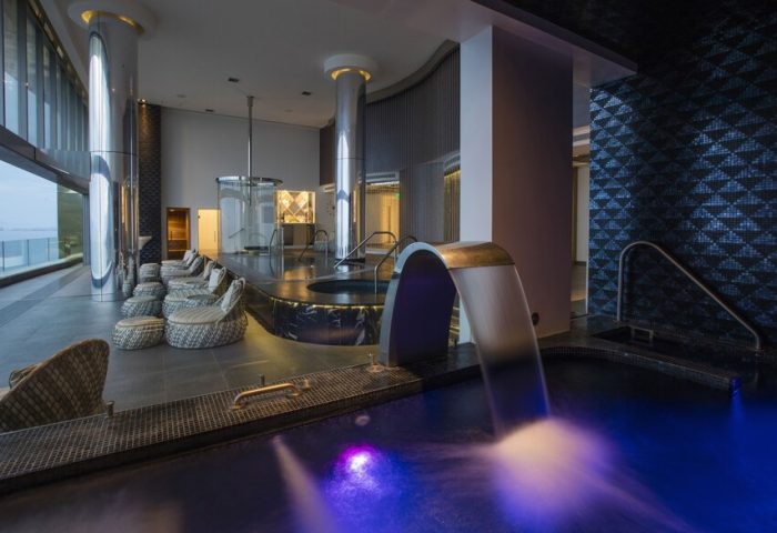 Hotel Mousai Cancun Adults Only All Inclusive spa. Gay-friendly hotel with pool, waterfall feature, lounge chairs, and ocean view.