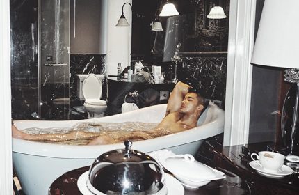 Man relaxing in tub at Hotel Muse Bangkok Langsuan MGallery Collection, a gay-friendly hotel with luxury amenities and stylish design.